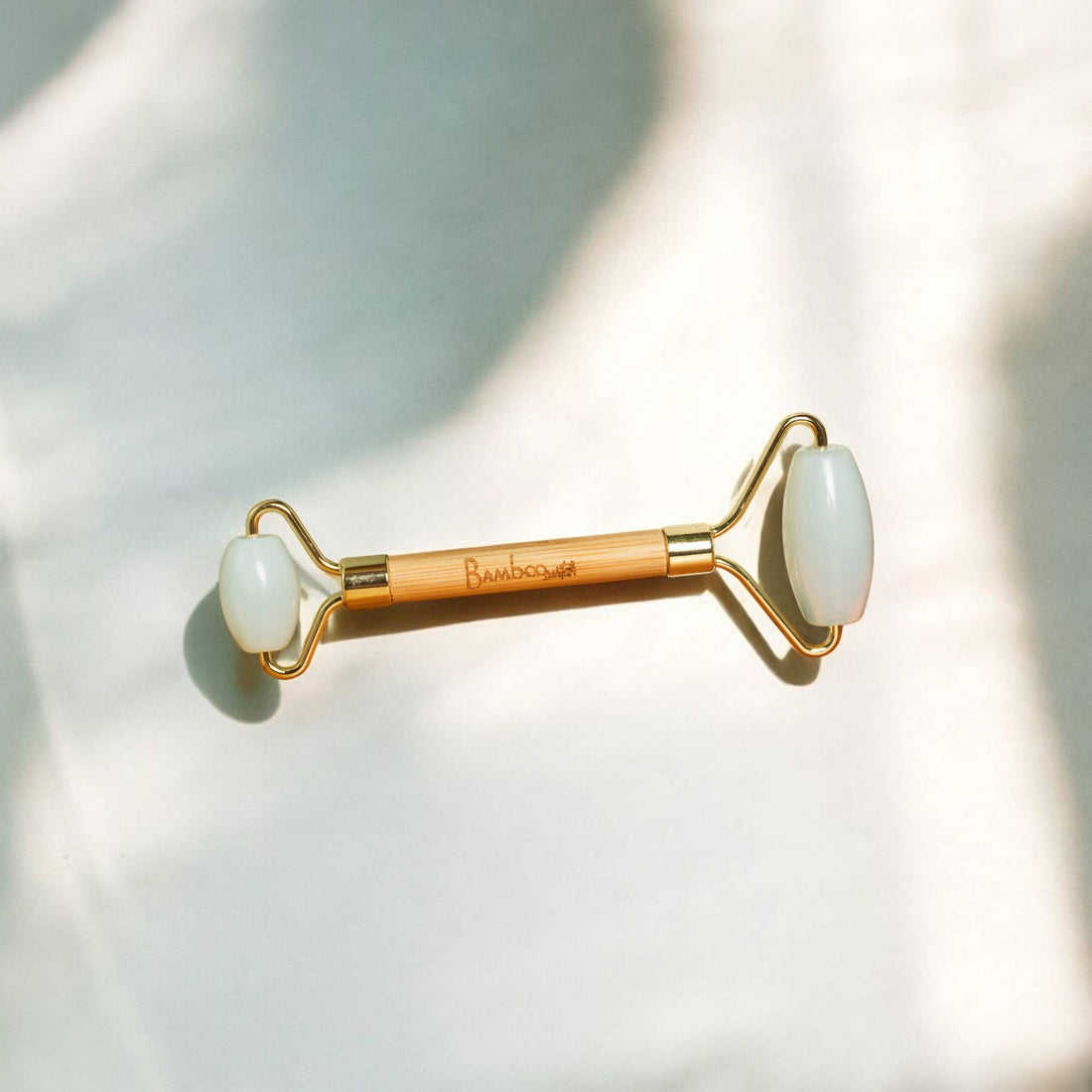 Bamboo Switch Dual Facial Roller with Opalite Stone for lymphatic drainage and facial massage.