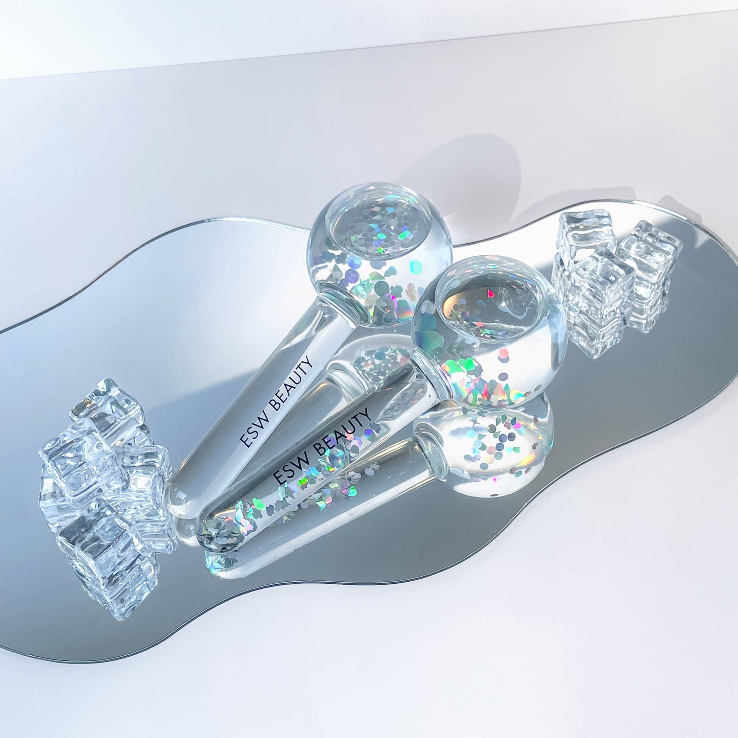 Close-up of ESW Beauty Glacial Duo Ice Globes showing the multi-color iridescent reflections of the pink glitter and glass.