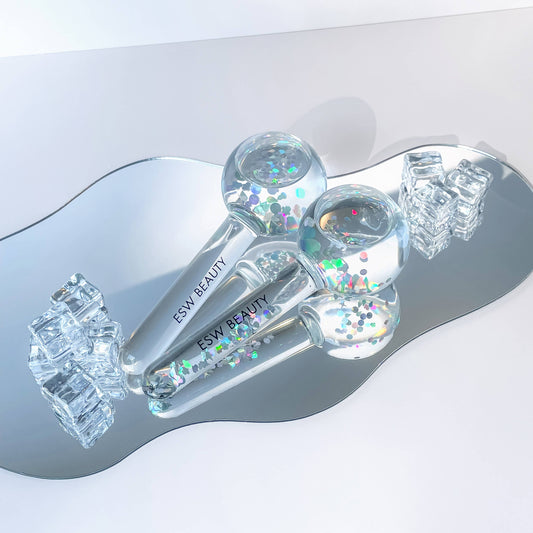 Close-up of ESW Beauty Glacial Duo Ice Globes showing the multi-color iridescent reflections of the pink glitter and glass.